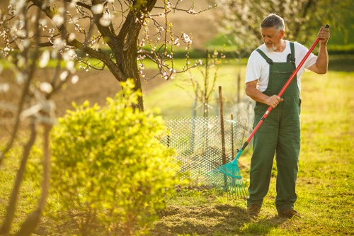 Local gardener in Dalston using PPE during garden maintenance